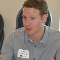 An alumnus explaining something at the 30 Minute Mentors Event